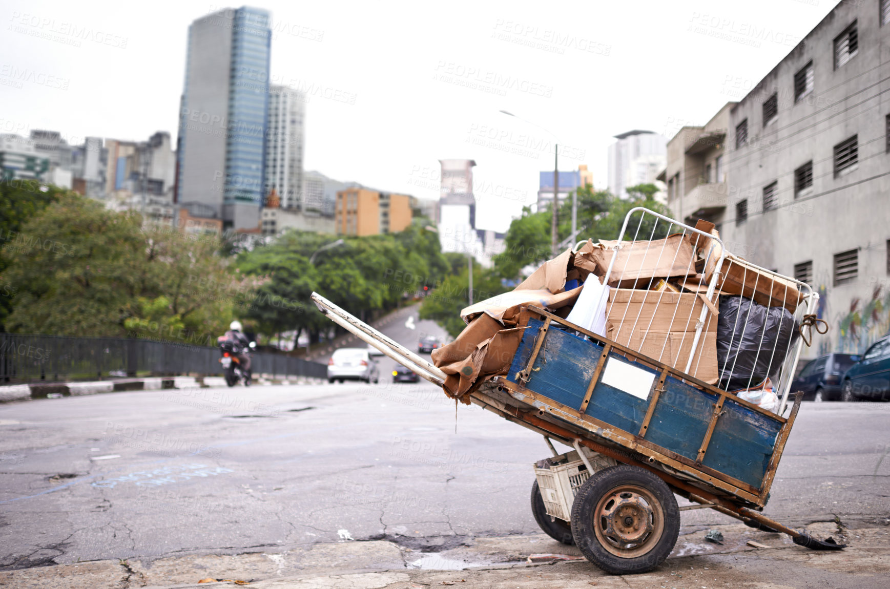 Buy stock photo Shot of a cart full of garbage in the street of a poverty-stricken city