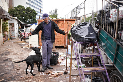 Buy stock photo Man, worker and cleaning of trash for waste management in junkyard with broom or playing with dog. Person, working or smile by dumpster site for scrap, recycling or garbage in neighborhood for litter