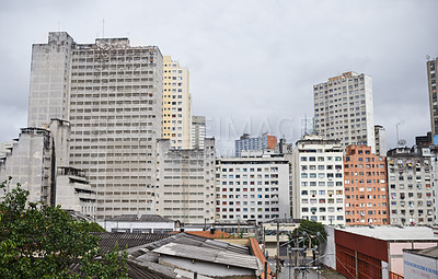 Buy stock photo Cityscape, skyline and buildings in urban architecture with development, expansion and clouds in sky. City, metro and skyscraper with road, fog or winter morning on location with road in Sao Paulo