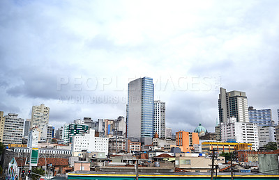 Buy stock photo Cityscape, skyline and buildings in urban architecture with development, expansion and clouds in town. City, metro and skyscraper on road, fog or winter morning on location with dark sky in Sao Paulo