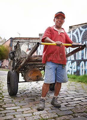 Buy stock photo Man, portrait and cart for trash in street for smile, walk and collect garbage for recycling for ecology. Person, rickshaw or barrow for sustainability, environment and favela on road in Sao Paulo