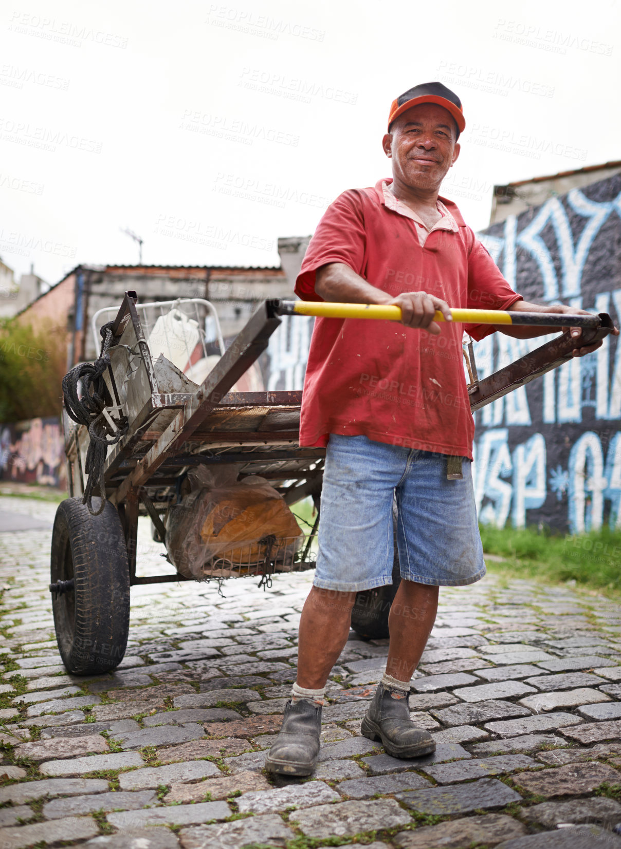 Buy stock photo Man, portrait and cart for trash in street for smile, walk and collect garbage for recycling for ecology. Person, rickshaw or barrow for sustainability, environment and favela on road in Sao Paulo