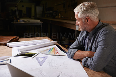 Buy stock photo Man, senior architect and blueprint drawing in workshop, professional designer and engineering. Architecture design, floor plan paperwork on table with designing equipment and creative male engineer