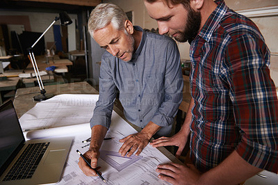 Buy stock photo Architect men, teamwork and drawing blueprint with discussion, construction goal or vision in workshop. Senior man, young male partner and paperwork for building, property or real estate development