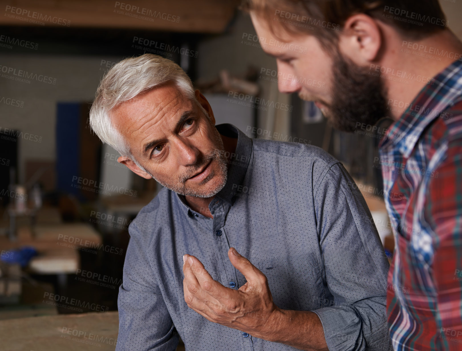 Buy stock photo Teaching, father and son in a workshop, discussion and skills with development, growth and bonding. Family, parent and dad with grown up child, planning and lesson with guidance, startup and talking 