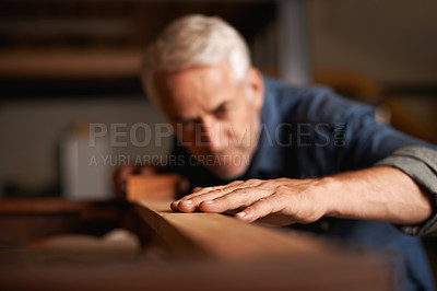 Buy stock photo Cropped shot of a senior man working with wood indoors