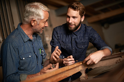 Buy stock photo Carpenter, mentor and furniture building in workshop, learning and talking in small business factory. Smile, happy and teaching of apprentice, professional and discussion of technique and skills