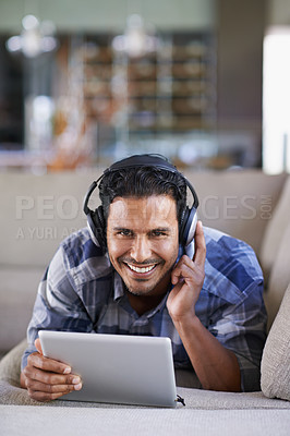 Buy stock photo Man, headphones and tablet for music or website, home and internet for streaming. Happy male person, relax and song app on couch for audio or podcast, smile and online for blog or subscription
