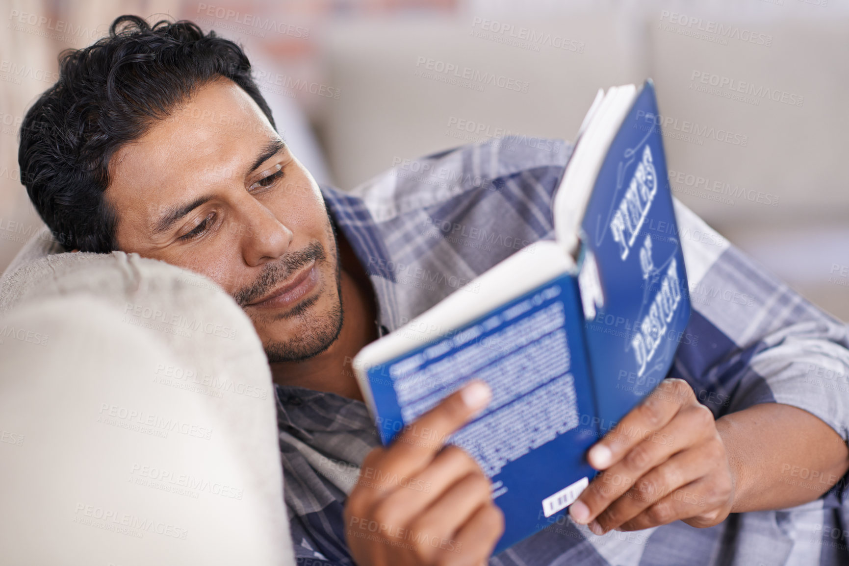 Buy stock photo Man, couch and reading a book for knowledge in home, literature and information. Happy male person, story and fiction novel for education in living room on weekend, comfortable and relax on sofa