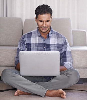 Buy stock photo Man, student and internet for laptop on floor of living room, education and scroll or browse on website. Male person, happy and online for information or home for app, sitting and elearning on tech 