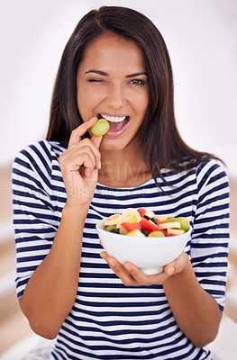 Buy stock photo Fruit, portrait and wink for healthy eating, bowl and wink with fresh food. Natural, nutrition or sustainable for vegetarian, fiber and breakfast or dessert for minerals and vitamins with grape