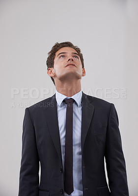 Buy stock photo Businessman, thinking and looking up with dream on mockup for idea on a gray studio background. Isolated young man, model or employee in business suit, wonder or thought for career plan or mindset