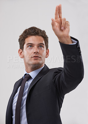 Buy stock photo Corporate, man and touching a digital interface in studio on white background for company research and ideas. Entrepreneur, male person and click for user experience with transformation technology