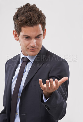 Buy stock photo Businessman, palm and hand with interaction for virtual display or hologram on a white studio background. Isolated young man, user or business employee showing gesture sign, symbol or 3D technology