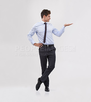 Buy stock photo Businessman, palm and presentation with mockup space for advertising, choice or selection on a gray studio background. Young man or business employee with hand out for marketing, decision or pick