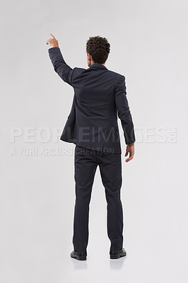Buy stock photo Rear view of a handsome young businessman touching a transparent digital interface