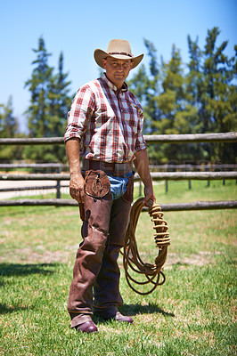 Buy stock photo A mature cowboy outdoors on his farm