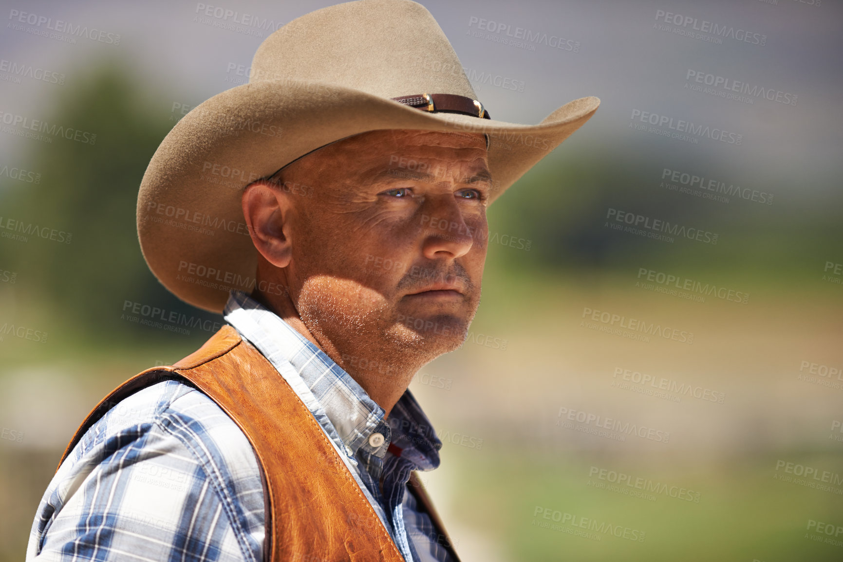 Buy stock photo Cowboy, ranch and thinking in outdoor, sun and serious for wrangler and Texas farmer at stable. Mature man, wild west and summer in agriculture, hat and person with shirt in farm job and environment