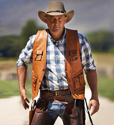 Buy stock photo Portrait, serious cowboy and man at farm in the rural countryside to draw gun in Texas. Ranch, confidence and male person in western hat outdoor in casual clothes in nature with pistol or revolver