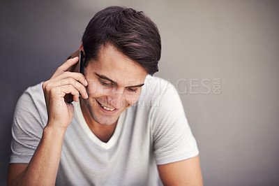 Buy stock photo Man, happy and phone call for talking in studio for communication on mobile network by background. Person, smartphone and listen with smile for chat, story or contact for conversation with connection