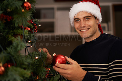 Buy stock photo Shot of a handsome young man getting ready for Christmas