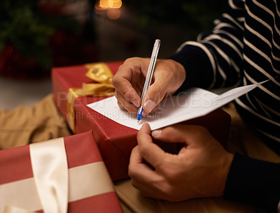 Buy stock photo Pen, hands and man with card and gift for Christmas event or party at home for family. Celebration, paper and closeup of male person writing letter with present boxes for xmas festive holiday.