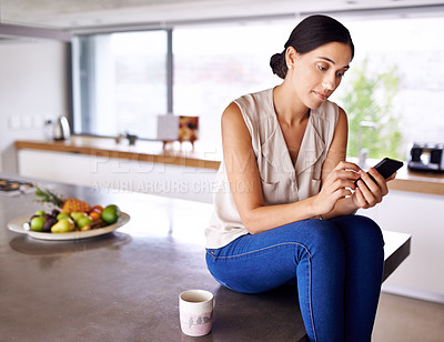 Buy stock photo Woman, kitchen counter and smartphone to browse social media for information, news update or entertainment. Female person, home and searching internet for online blog, mobile app and website.  

