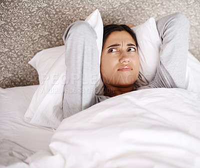 Buy stock photo A young woman looking frustrated in bed