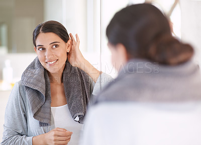 Buy stock photo A young woman drying her hair after a shower