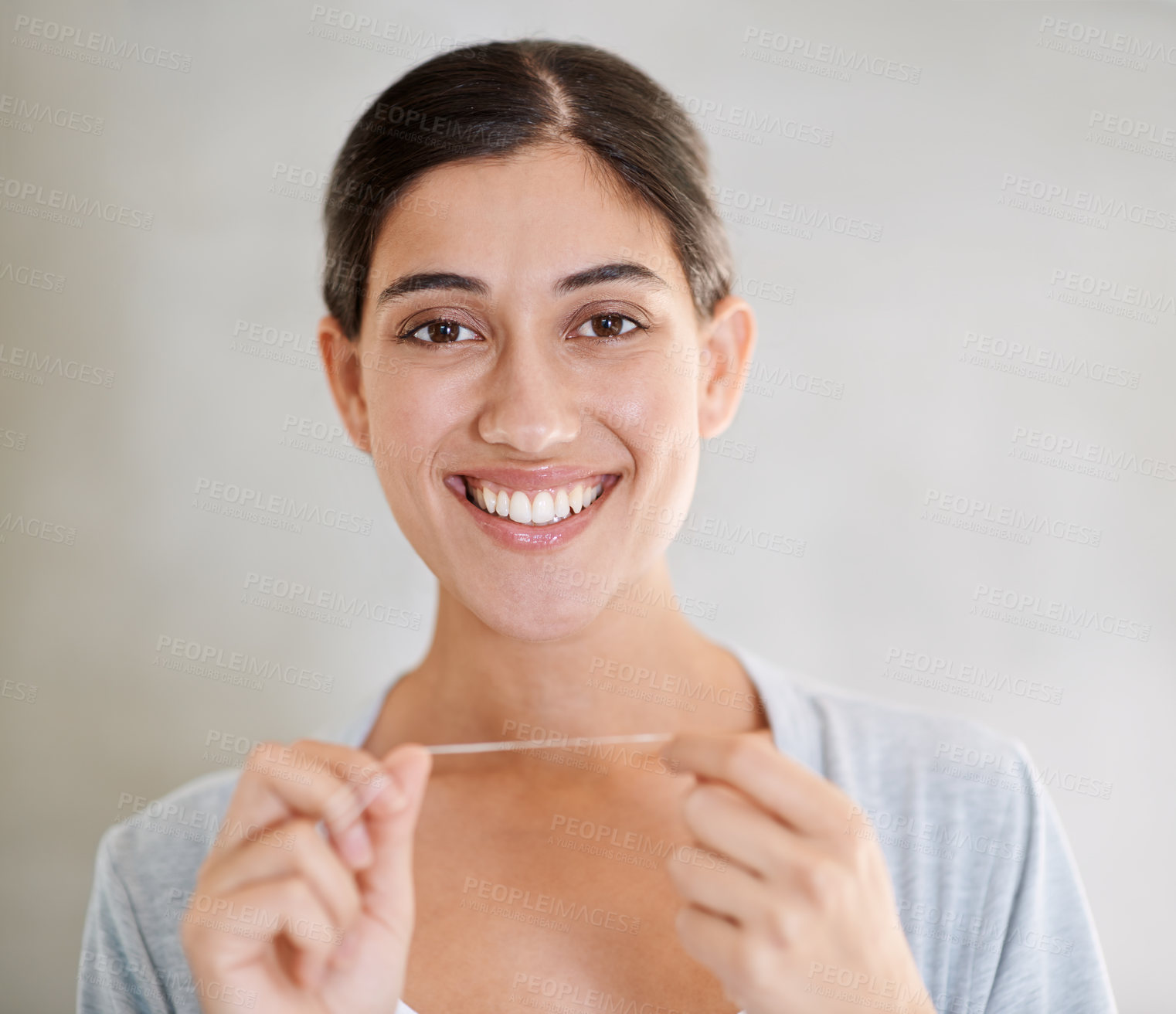 Buy stock photo Portrait of an attractive young woman flossing her teeth