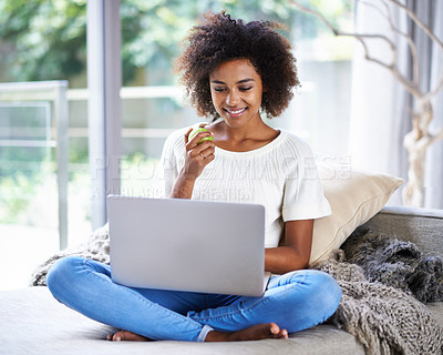 Buy stock photo Apple, smile and woman on sofa with laptop for social media, lifestyle blog and food website at home in Houston. Happy female person, technology and fruit for nutrition, healthy diet and clean eating