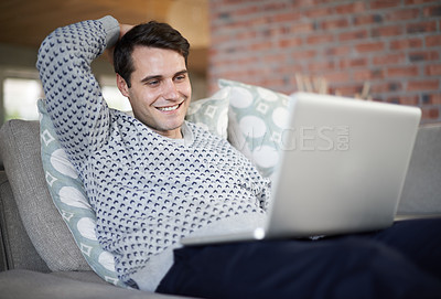 Buy stock photo Relax, happy or man on laptop for streaming movies, article post or networking in home to research. Email, smile or male person on sofa typing online on technology for digital blog or news on website