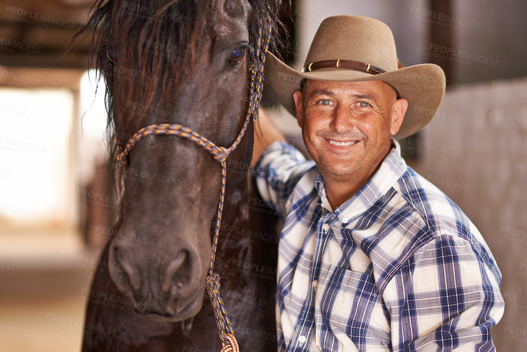 Buy stock photo Cowboy, man and horse in stable with smile in portrait for care, growth or development at farm, ranch or countryside. Person, animal or equine pet with love, happy or connection for wellness in Texas