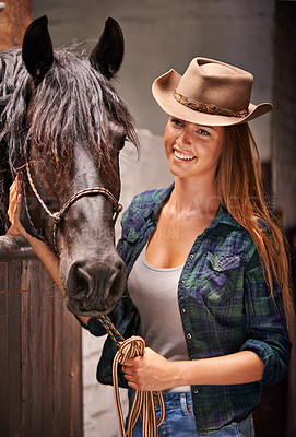 Buy stock photo Horse, farm and ranch with young woman in barn or stable for work in agriculture or sustainability. Cowgirl, texas or western and happy animal farmer or owner with stallion for equestrian training