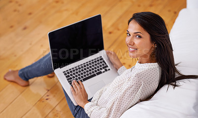 Buy stock photo Woman, house and laptop on sofa, screen and lounge for portrait, smile and confidence in remote work. Female person, tech and for entertainment and social media blog for article and casual wear