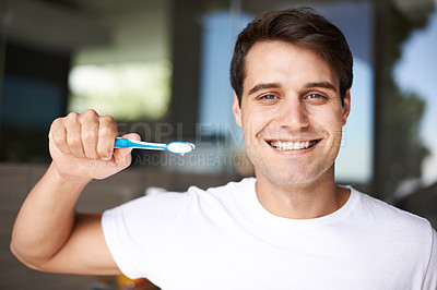 Buy stock photo Brushing teeth, man portrait and cleaning in a bathroom at home for oral hygiene and health. Smile, dental and toothbrush with a male person with happiness in the morning at a house with care