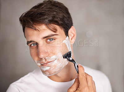 Buy stock photo Foam, shaving and portrait of man in bathroom for facial grooming, wellness and skincare at home. Health, cosmetics and male person shave beard for face hygiene, cleaning and hair removal with razor