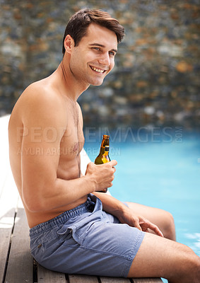 Buy stock photo Man, enjoy and happy by swimming pool with beer to relax or chill on summer vacation, luxury and resort or villa. Male person, bottle and alcohol for refreshments on tropical holiday in Maldives.
