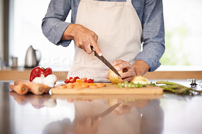 Buy stock photo Cropped shot of a man chopping up some vegtables