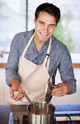 Buy stock photo Portrait of a young man preparing a meal at home