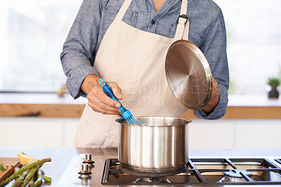 Buy stock photo Hands, chef and cooking in kitchen with pot, wellness and food with nutrition for health in home. House, stove and person with apron for fresh ingredients to eat for lunch, diet and soup on gas