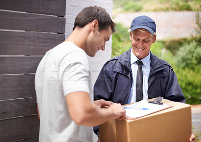 Buy stock photo Shot of a young man receiving a parcel from the delivery man