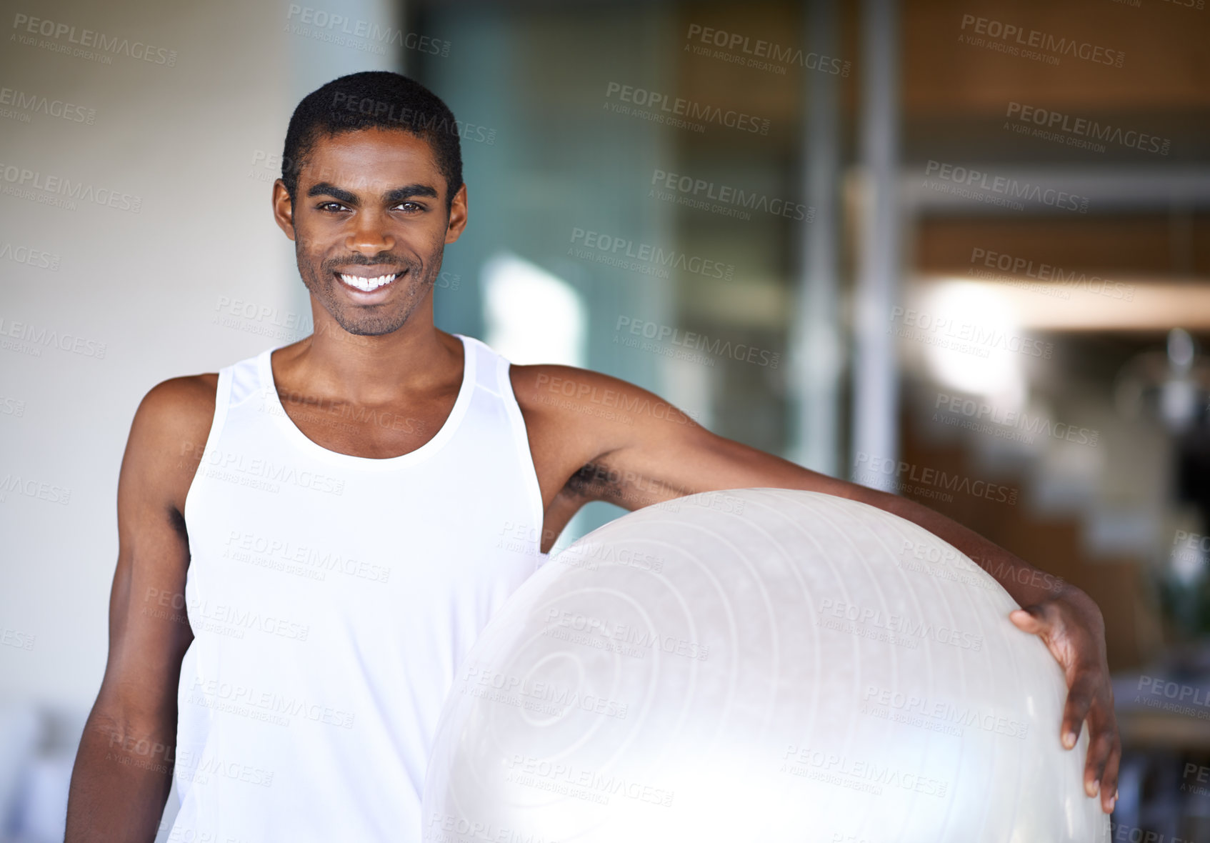 Buy stock photo Portrait of a smiling young man holding a fitness ball