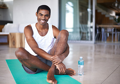 Buy stock photo Shot of a handsome young man exercising in his home