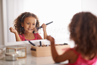 Buy stock photo Kid, girl and smile with brush for makeup in mirror for creativity and artistic skills. Child, female person and happy at home with playing for development, growth and cute with childhood memories.