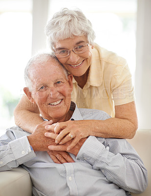 Buy stock photo Couple, senior and hug or portrait on couch, home and relax together for bonding and smile. Elderly people, embrace and care in marriage or relationship in retirement, love and security in house