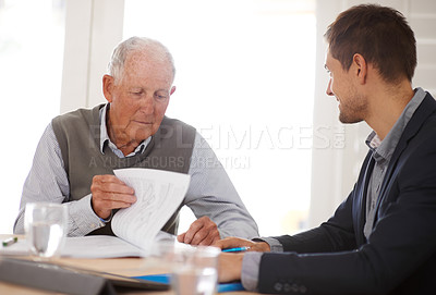 Buy stock photo A young businessman explaining information to an elderly man