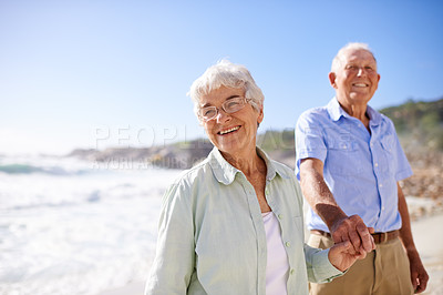 Buy stock photo Elderly, couple and walk on beach for portrait on retirement vacation or anniversary to relax with love, care and commitment with support. Senior man, woman and together by ocean for peace on holiday