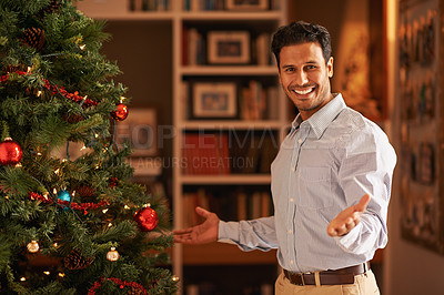 Buy stock photo Happy man, portrait and Christmas tree with welcome for festive, celebration or December at home. Young male person with smile for decoration, present or gift giving in living room at the house