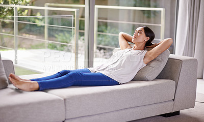 Buy stock photo Shot of a young woman napping on a sofa